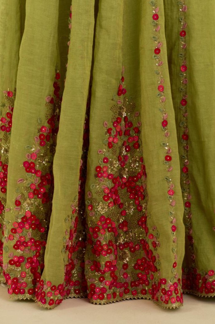 Green tissue chanderi lehenga with all-over delicate hand cut silk flower embroidery, highlighted with gold sequins.