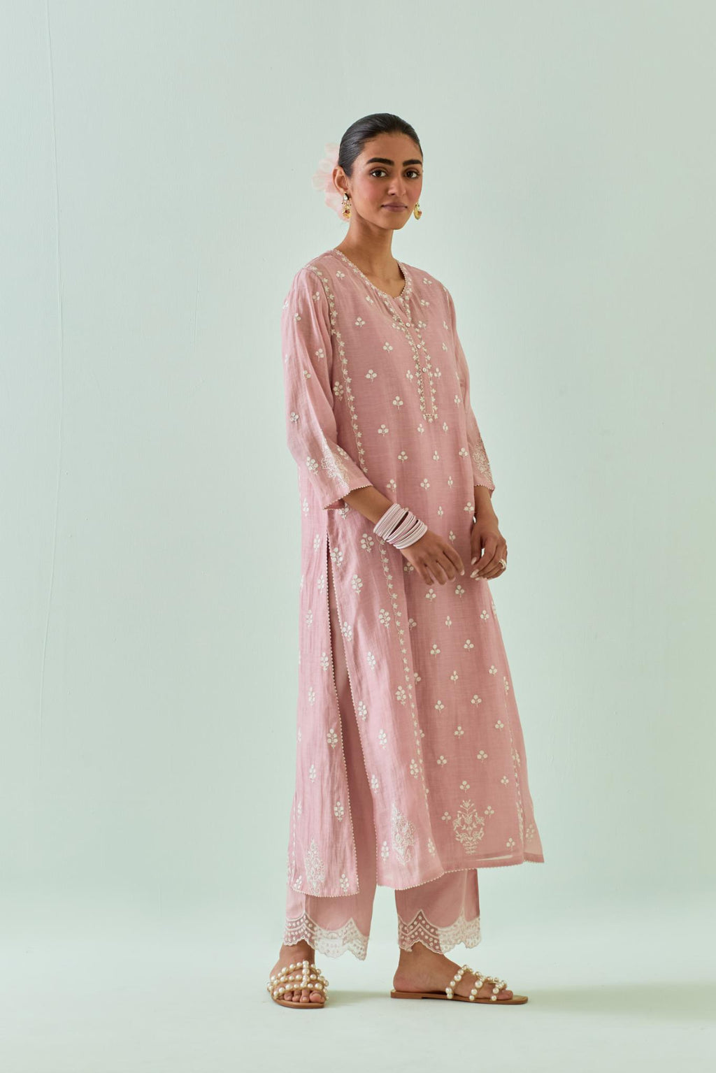 Pink straight kurta set with all-over off white Dori embroidery, highlighted with delicate beaded work and embroidery detail at side panel joint seams.
