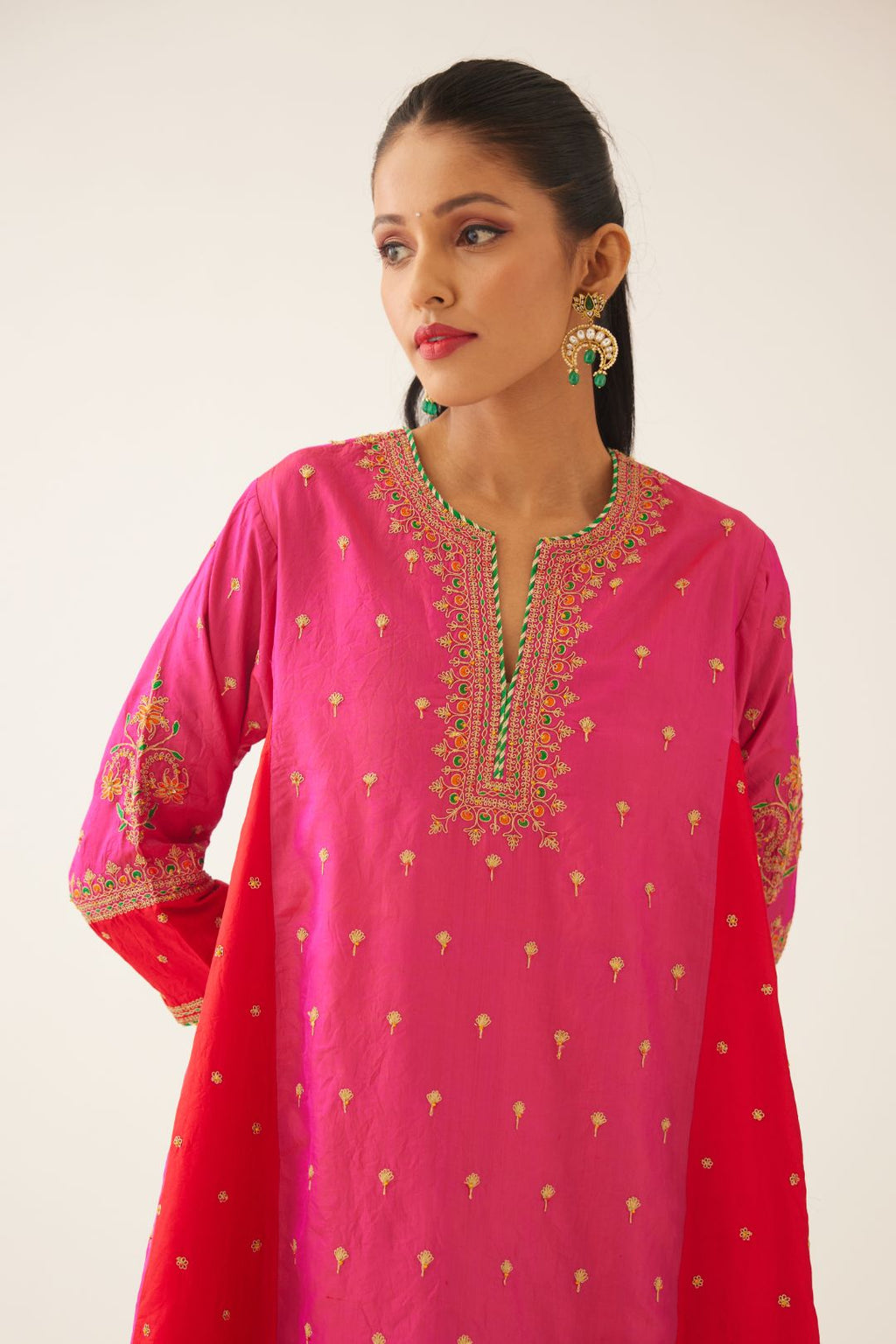 Red & fuchsia silk short kalidar kurta set with all over dori & silk thread embroidery, highlighted with contrast bead & sequins work.
