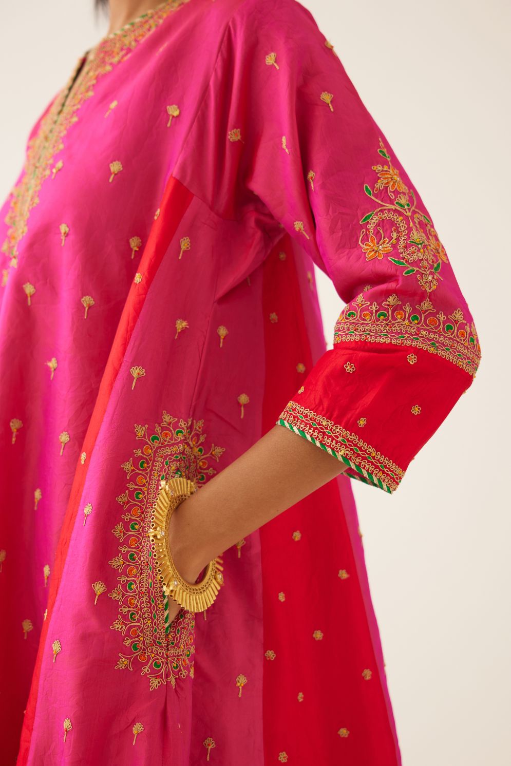 Red & fuchsia silk short kalidar kurta set with all over dori & silk thread embroidery, highlighted with contrast bead & sequins work.