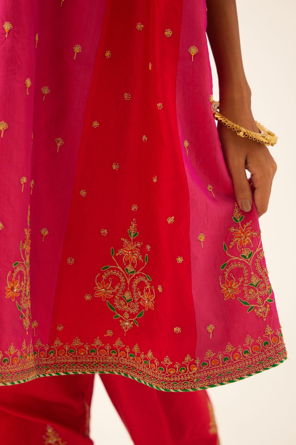 Red & fuchsia silk short kalidar kurta set with all over dori & silk thread embroidery, highlighted with contrast bead & sequins work.
