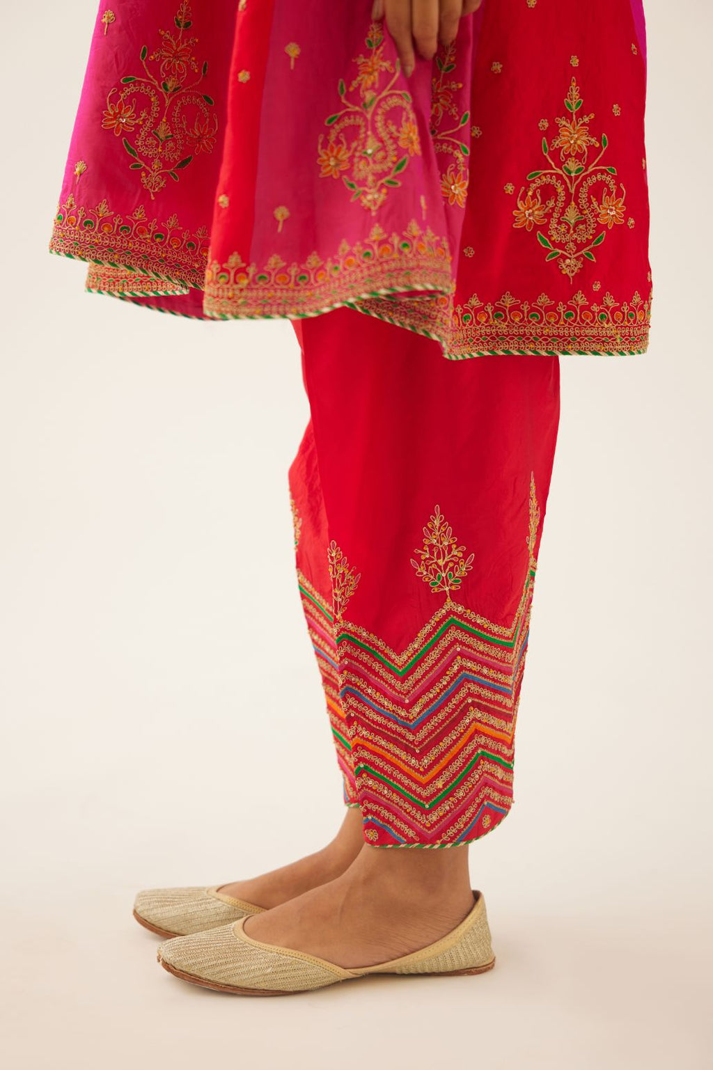 Red & fuchsia silk short kalidar kurta set with all over dori & silk thread embroidery, highlighted with contrast bead & sequins work.