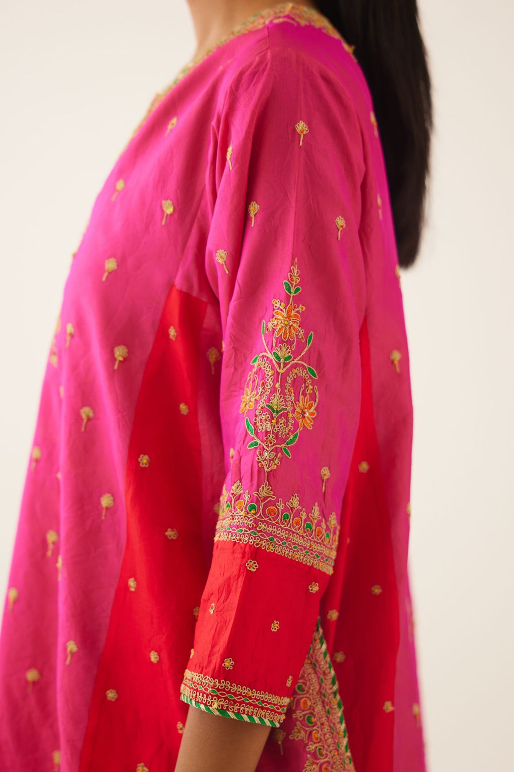 Red & fuchsia silk short kalidar kurta set with all over dori & silk thread embroidery, highlighted with contrast bead & sequins work.