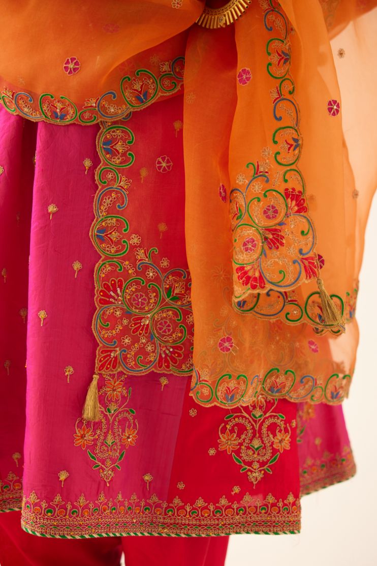 Red & fuchsia silk short kalidar kurta set with all over dori & silk thread embroidery, highlighted with contrast bead & sequins work.