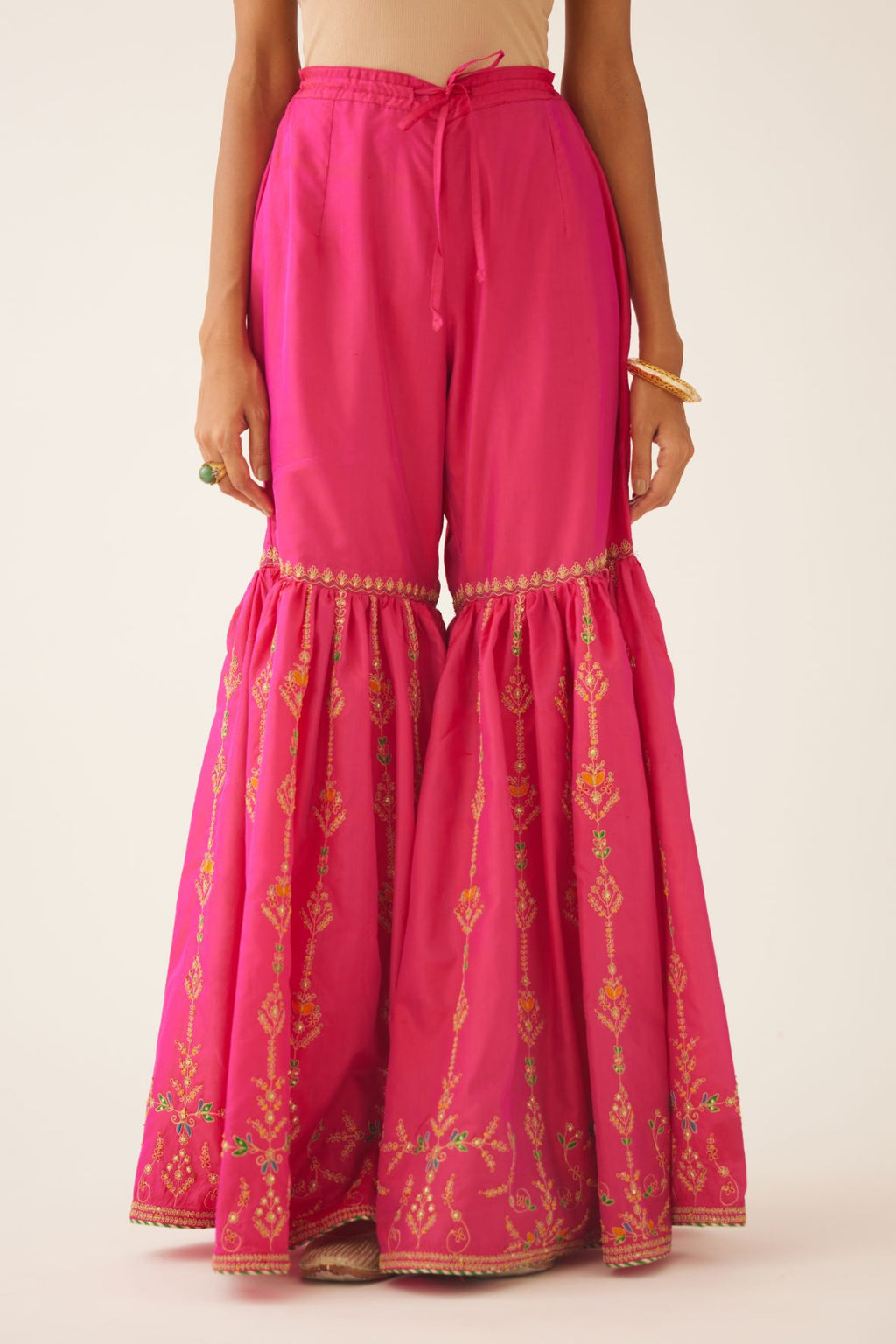 Raspberry silk farshi with delicate dori and silk thread embroidery, highlighted with dori embroidery at knee joint seam.