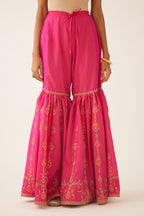 Raspberry silk farshi with delicate dori and silk thread embroidery, highlighted with dori embroidery at knee joint seam.
