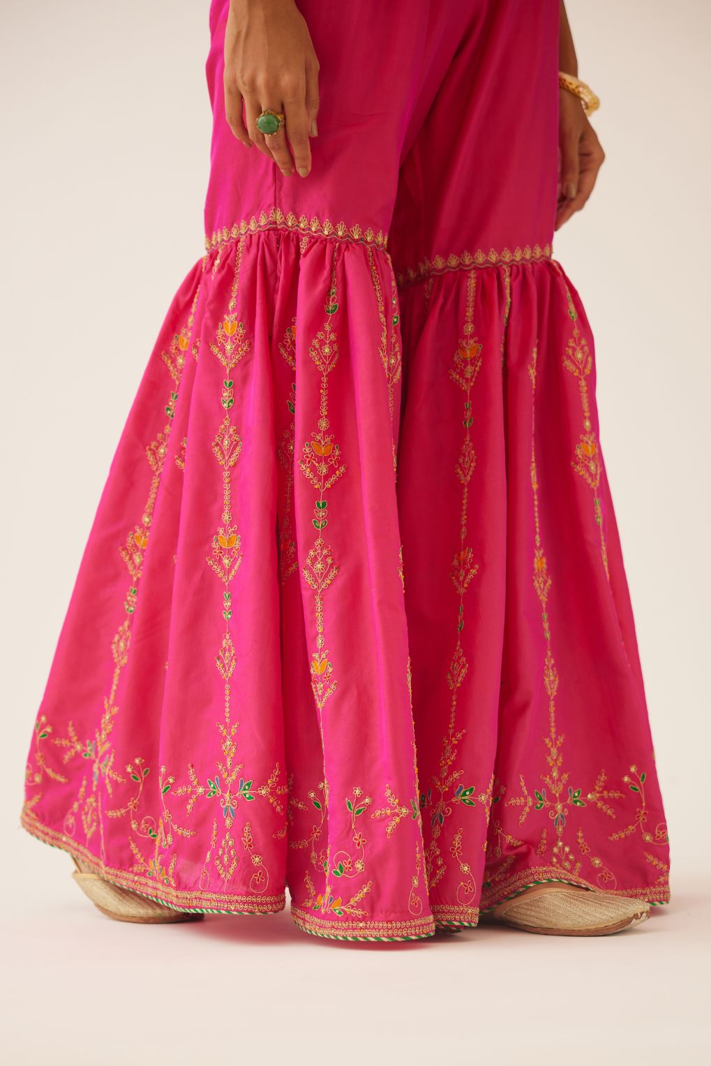 Raspberry silk farshi with delicate dori and silk thread embroidery, highlighted with dori embroidery at knee joint seam.
