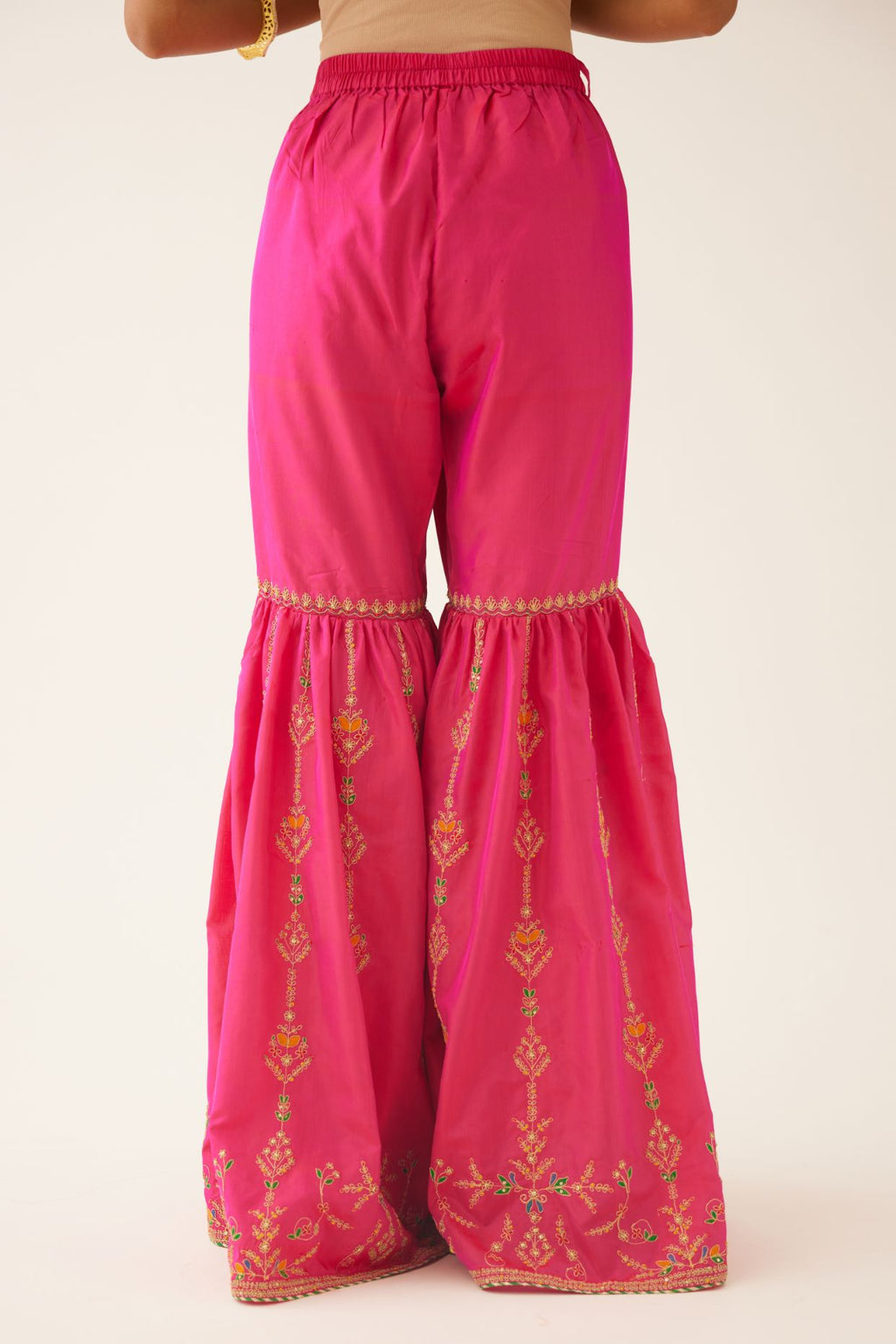 Raspberry silk farshi with delicate dori and silk thread embroidery, highlighted with dori embroidery at knee joint seam.