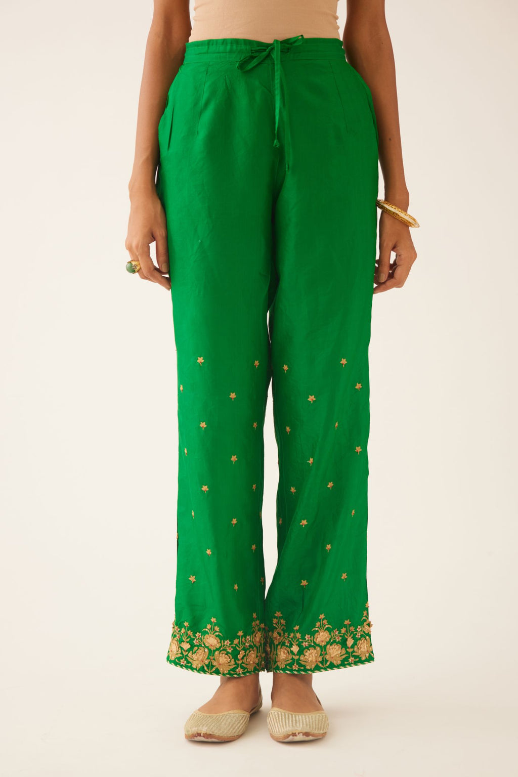 Green silk pants, hem is detailed with zari & gota embroidery