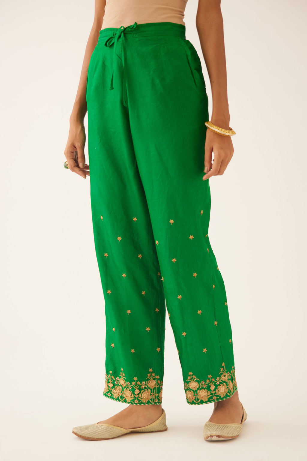 Green silk pants, hem is detailed with zari & gota embroidery