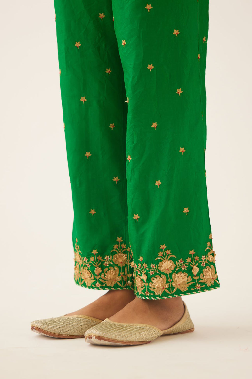 Green silk pants, hem is detailed with zari & gota embroidery