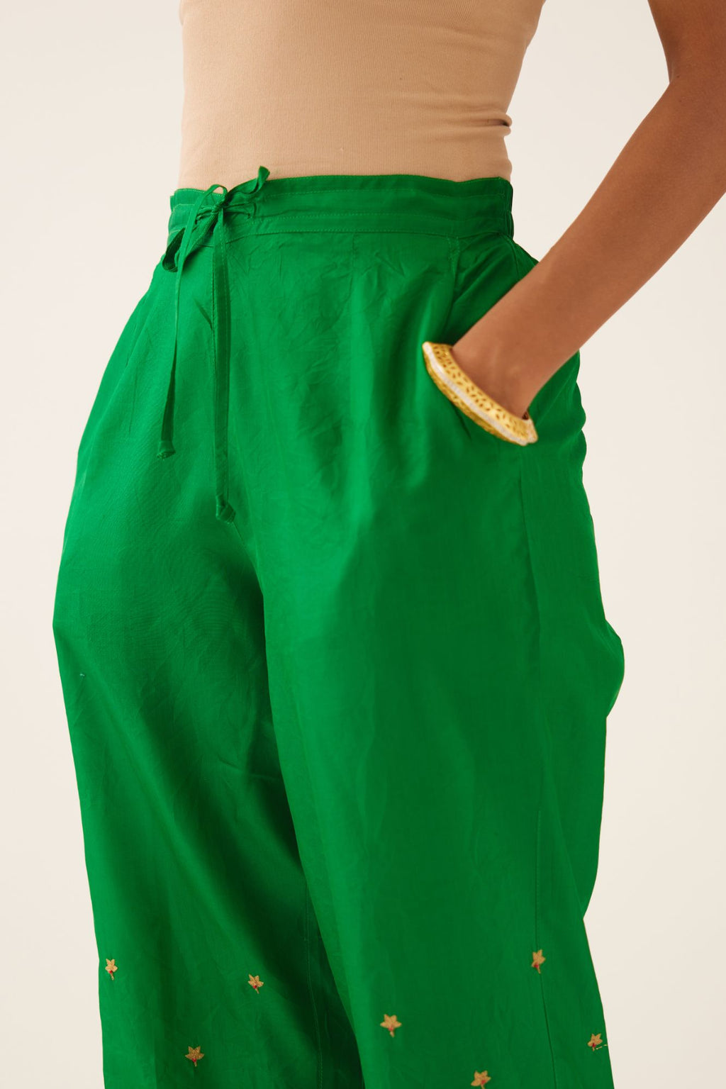Green silk pants, hem is detailed with zari & gota embroidery