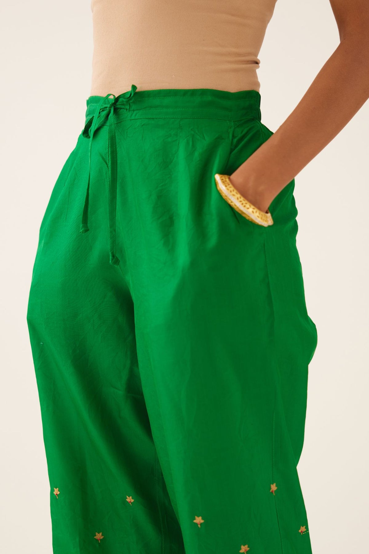 Green silk pants, hem is detailed with zari & gota embroidery