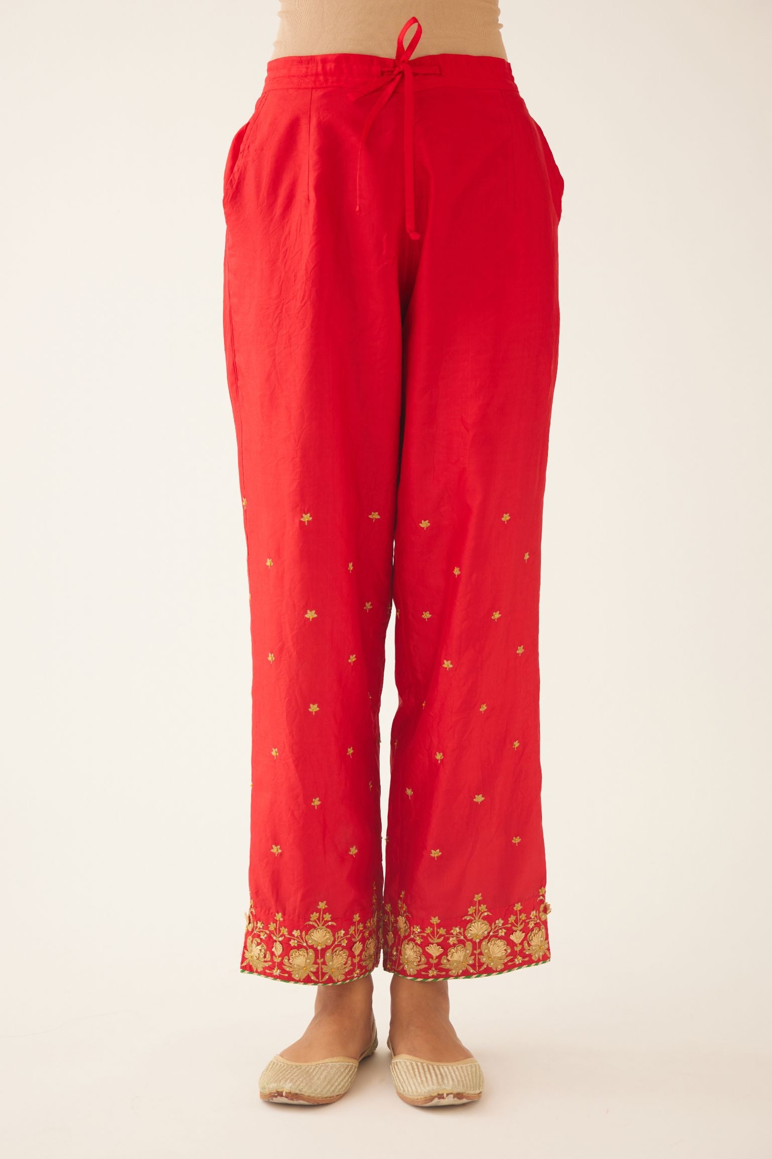 Red silk pants, hem is detailed with zari & gota embroidery