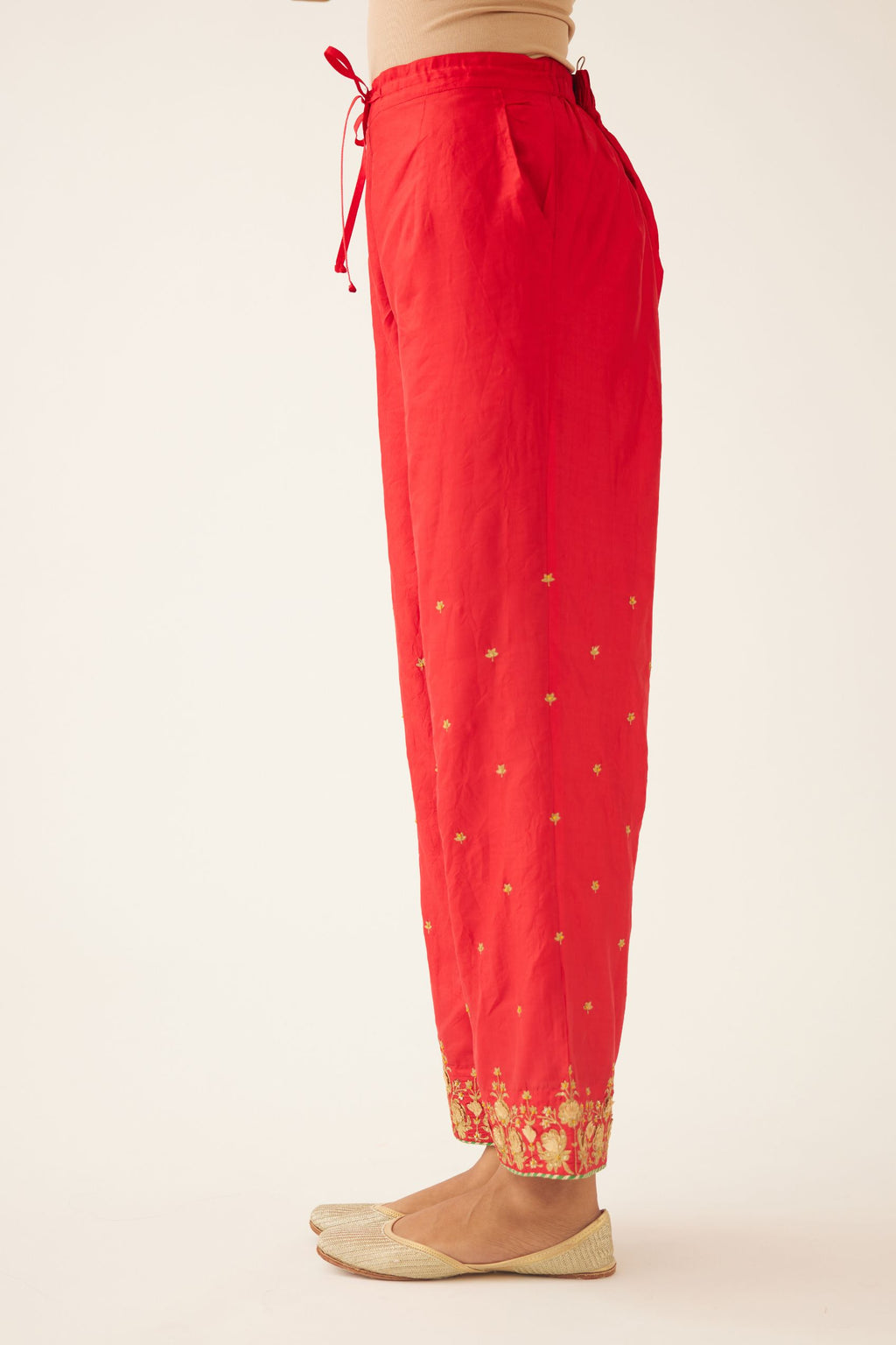 Red silk pants, hem is detailed with zari & gota embroidery