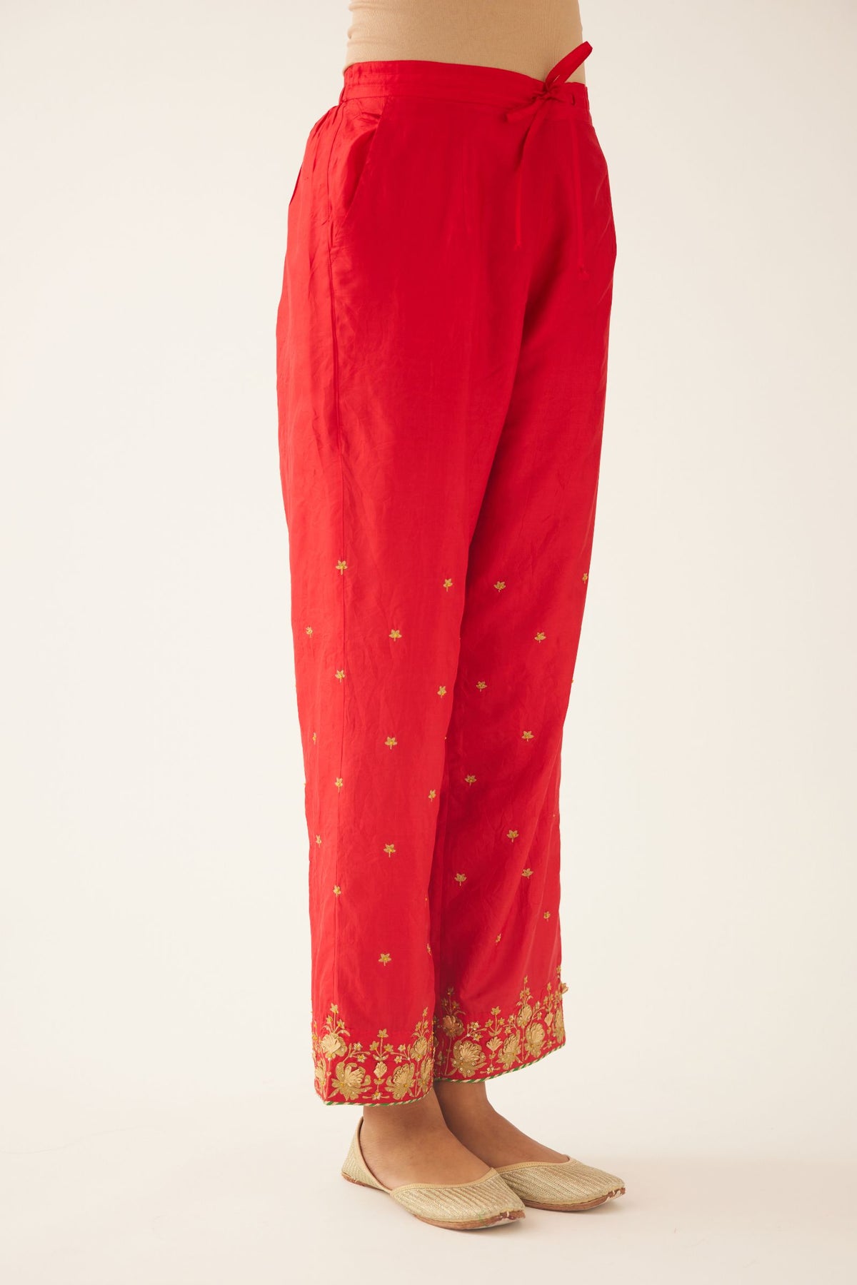 Red silk pants, hem is detailed with zari & gota embroidery