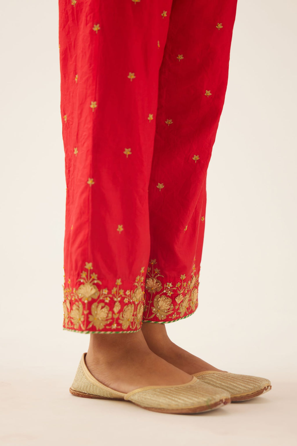 Red silk pants, hem is detailed with zari & gota embroidery