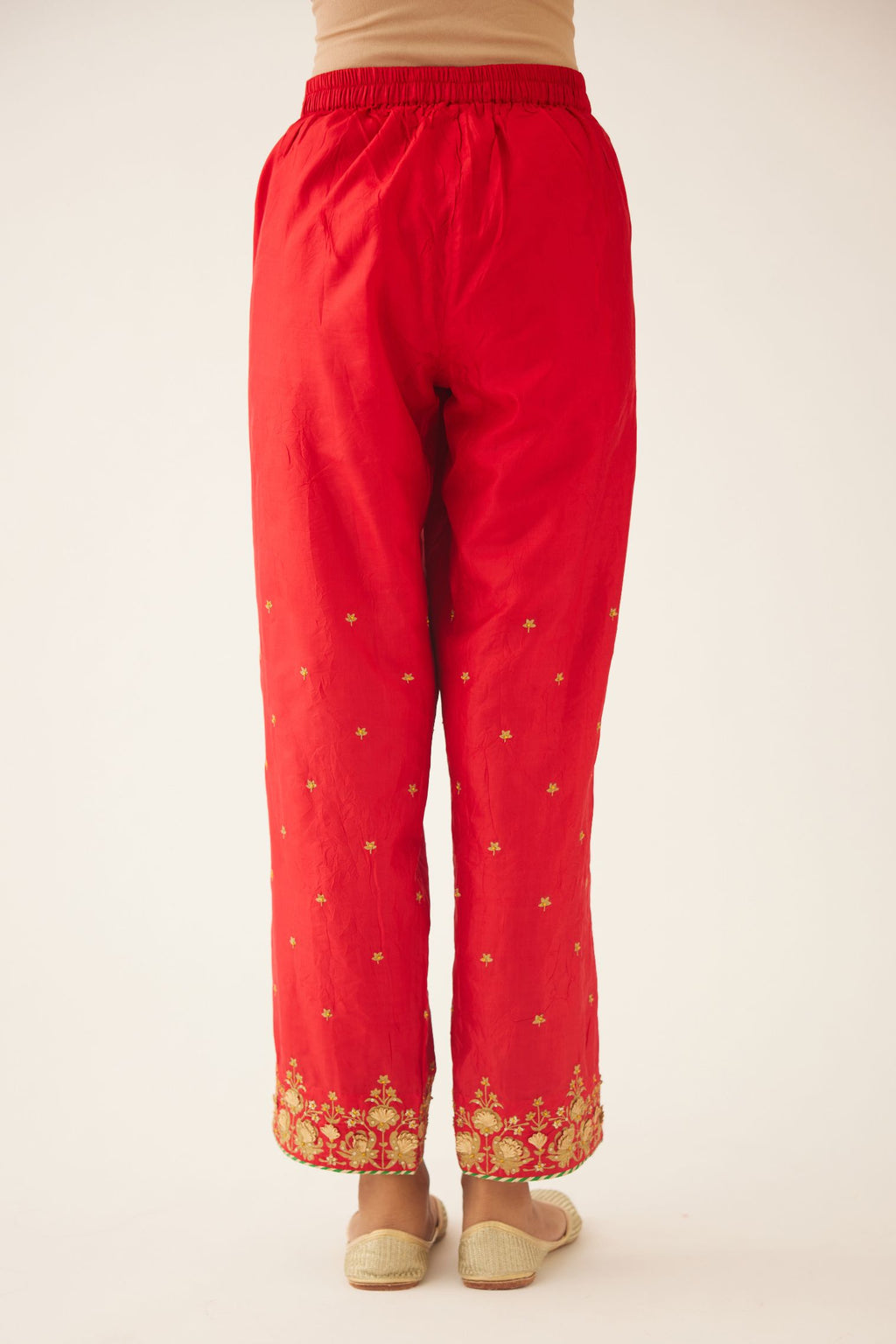Red silk pants, hem is detailed with zari & gota embroidery