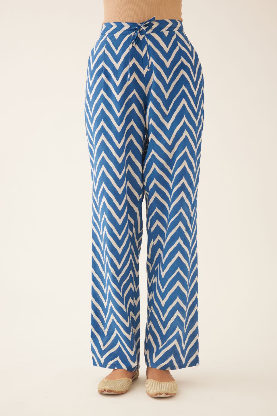 Blue & off white cotton hand block printed straight pants detailed with sequin and bead work at hem.