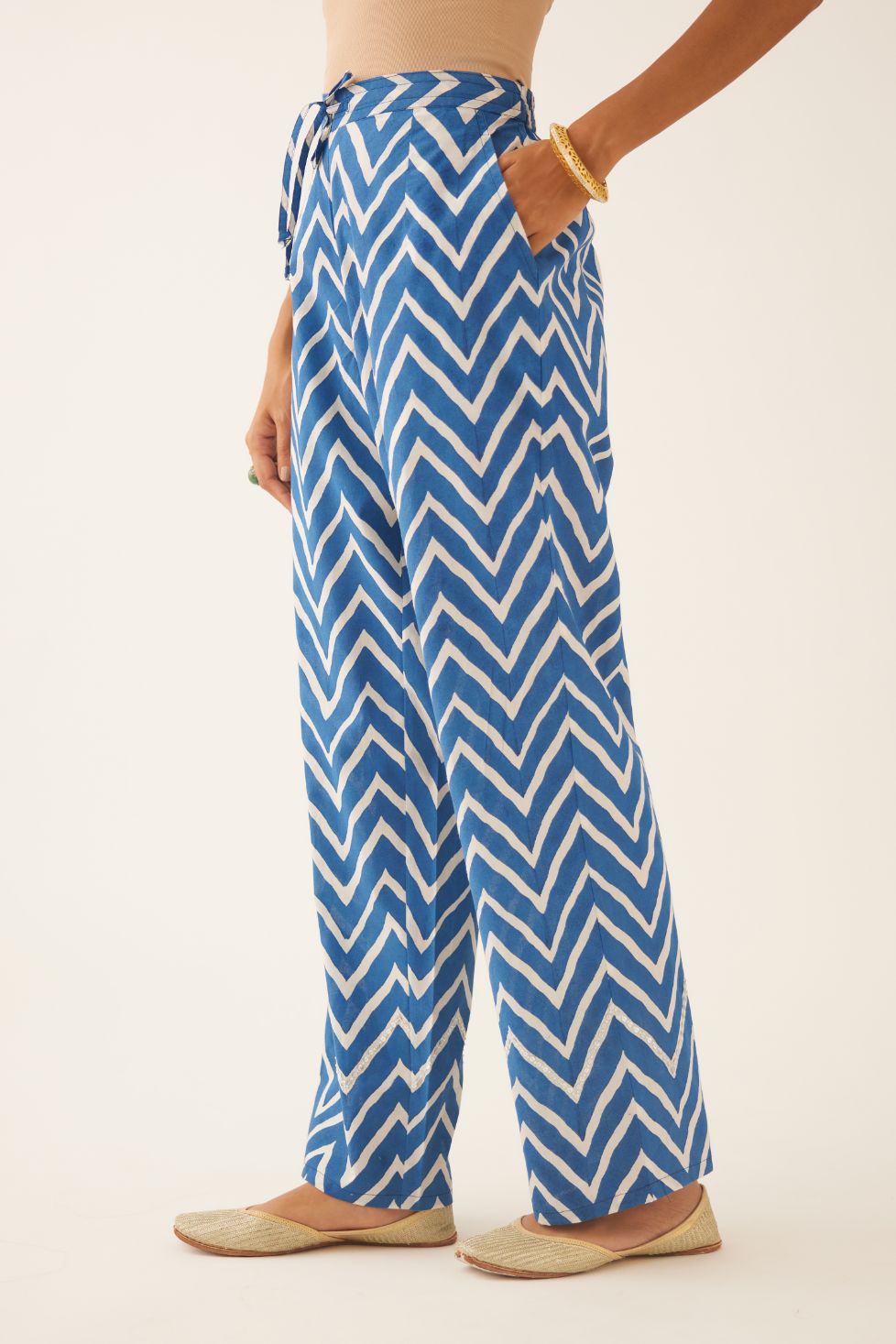 Blue & off white cotton hand block printed straight pants detailed with sequin and bead work at hem.