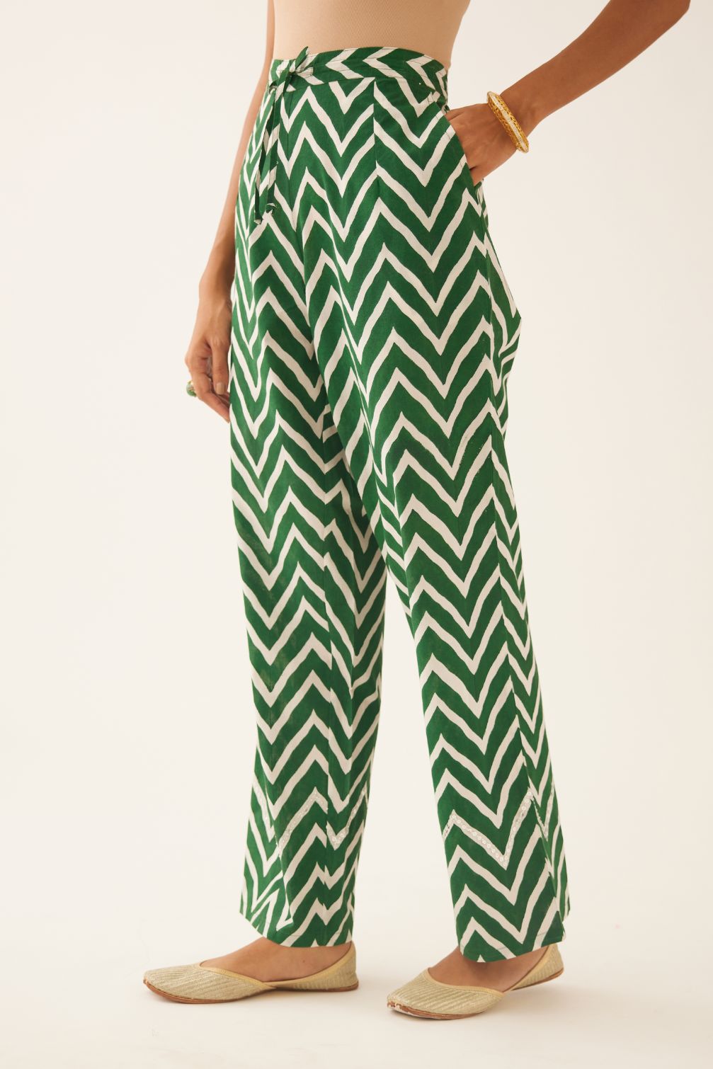 Green & off white cotton hand block printed straight pants detailed with sequin and bead work at hem.