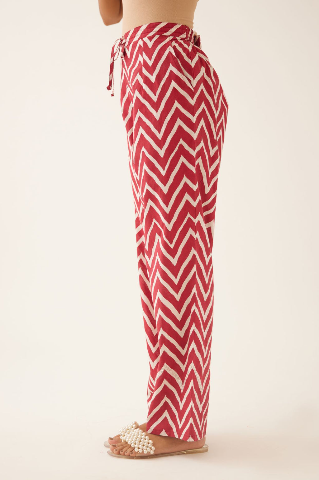Red & off white cotton hand block printed straight pants detailed with sequin and bead work at hem.