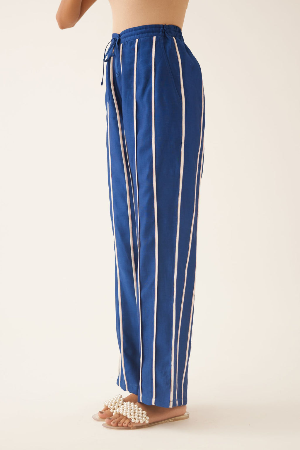 Blue silk chanderi straight pants with vertical off white piping detail.