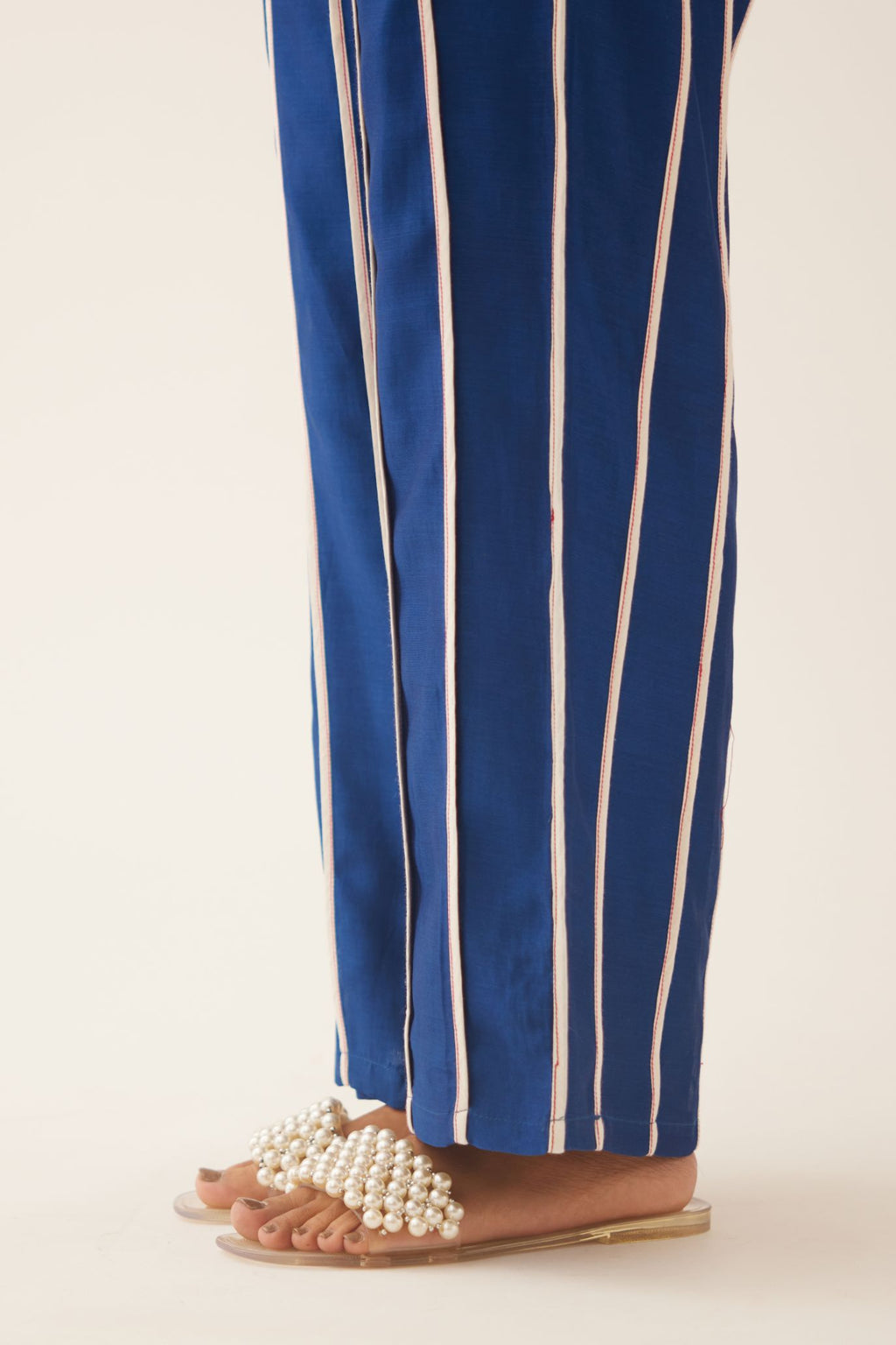 Blue silk chanderi straight pants with vertical off white piping detail.