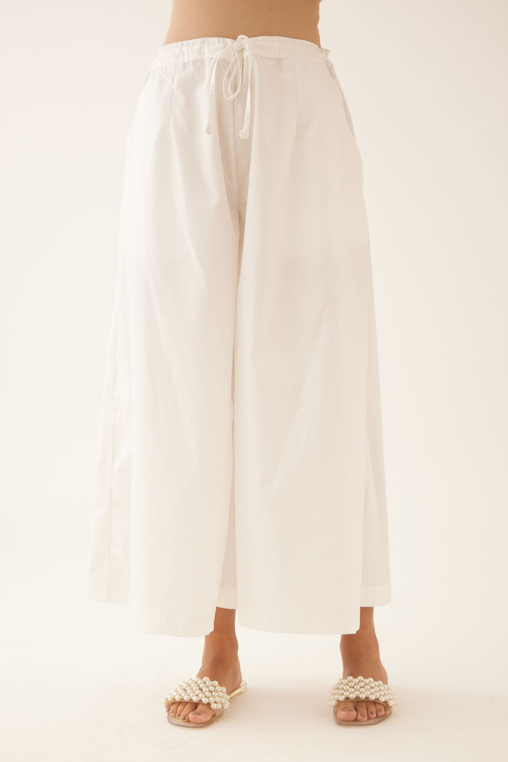 Off white cotton wide leg pants with side pockets.