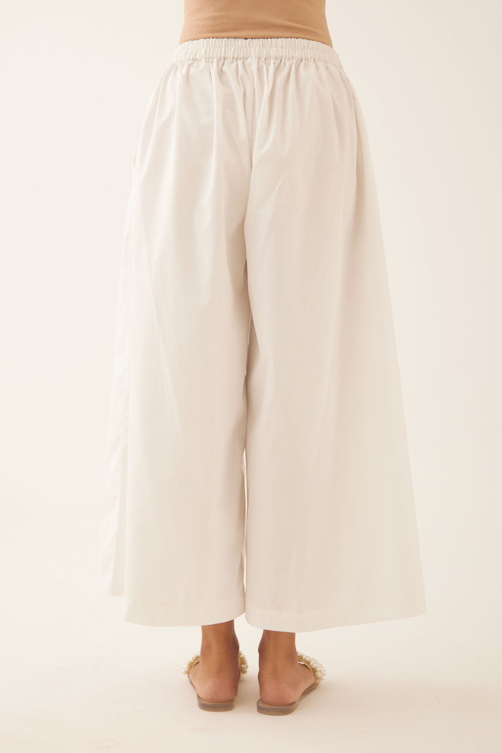 Off white cotton wide leg pants with side pockets.