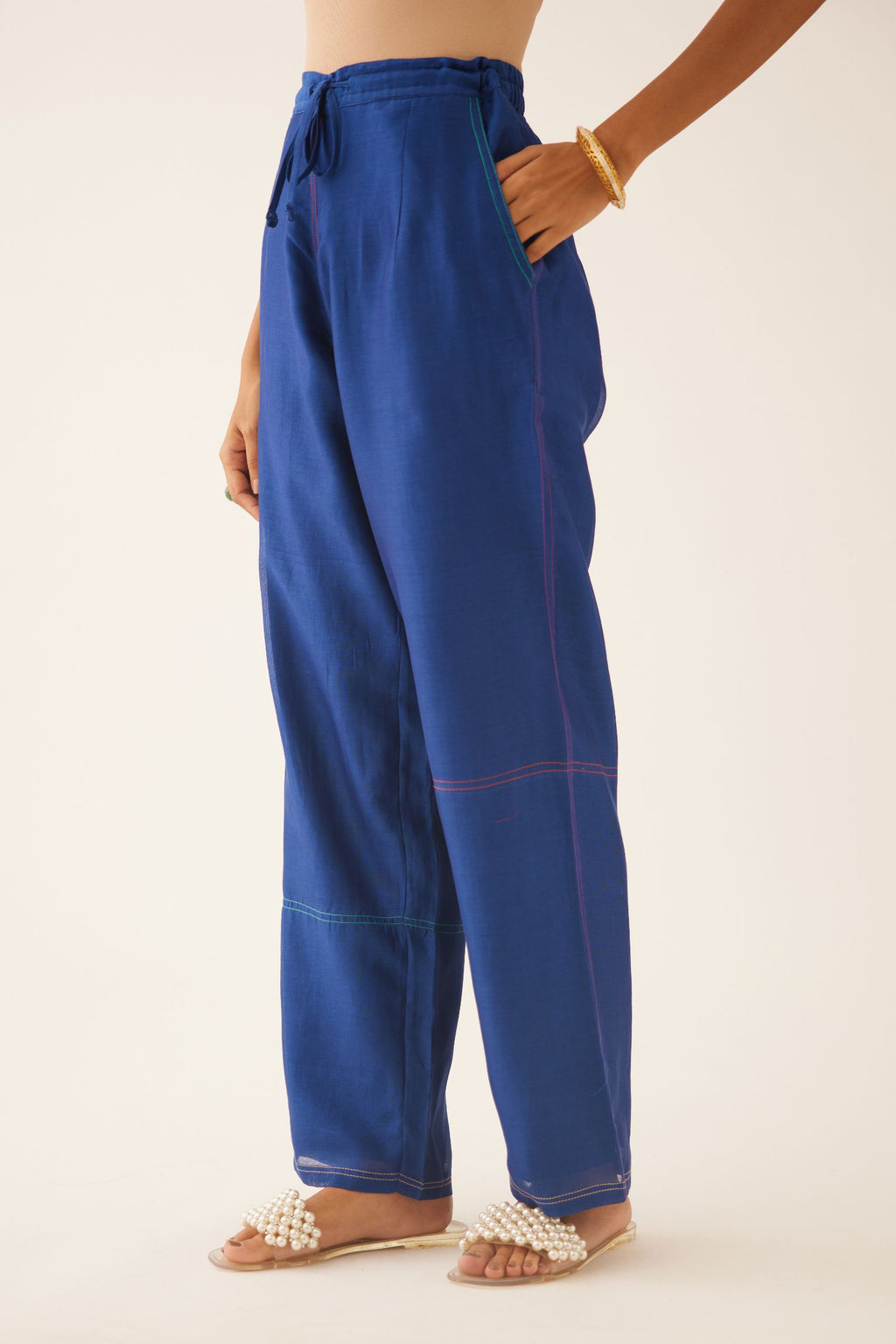 Blue silk chanderi straight pants, highlighted with multi colored thread stitch detail.