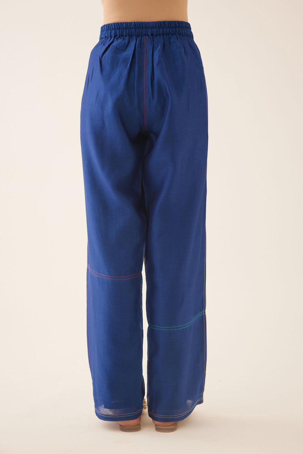 Blue silk chanderi straight pants, highlighted with multi colored thread stitch detail.