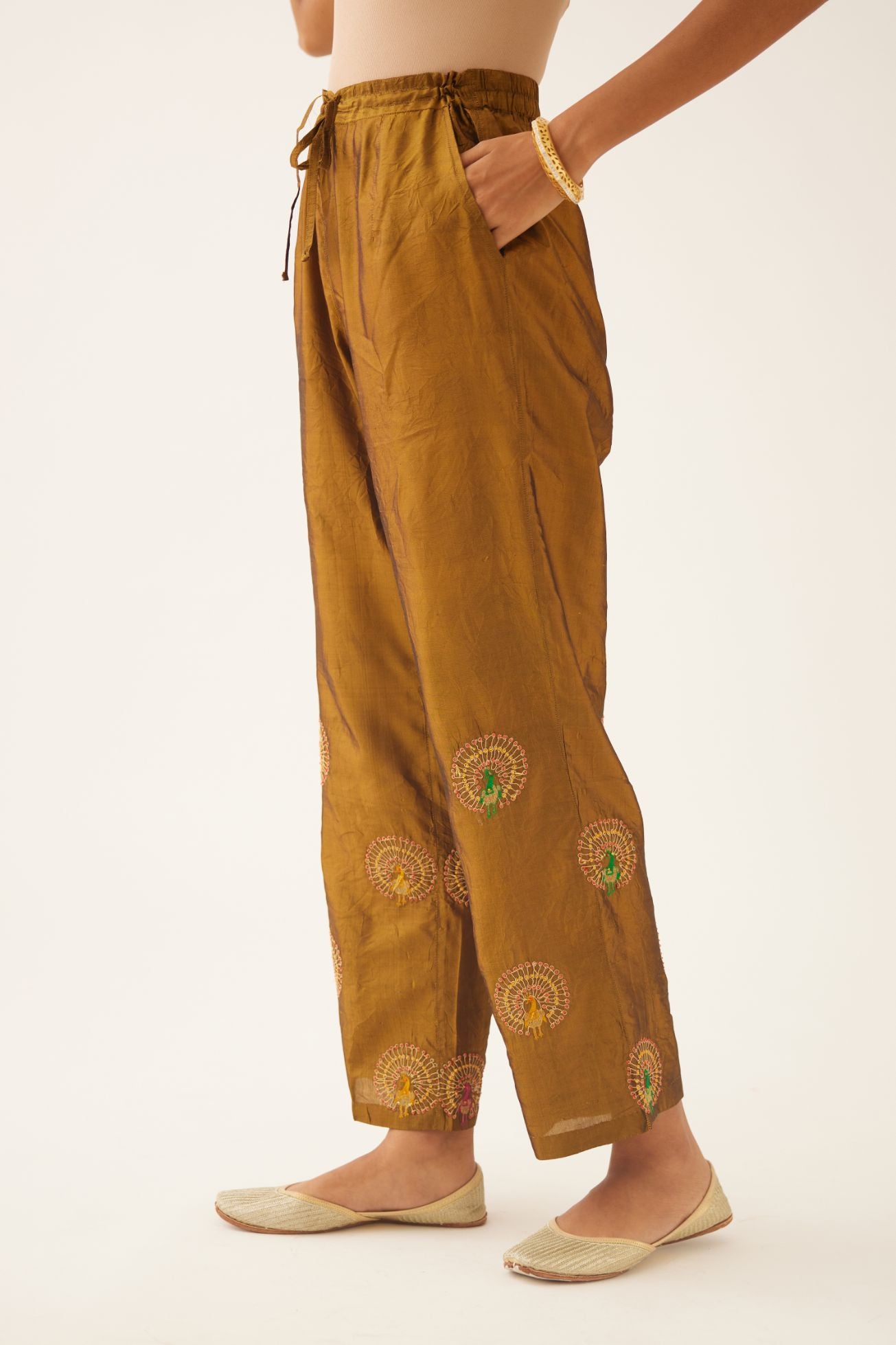 Golden olive silk straight pants with dori and silk thread embroidery.