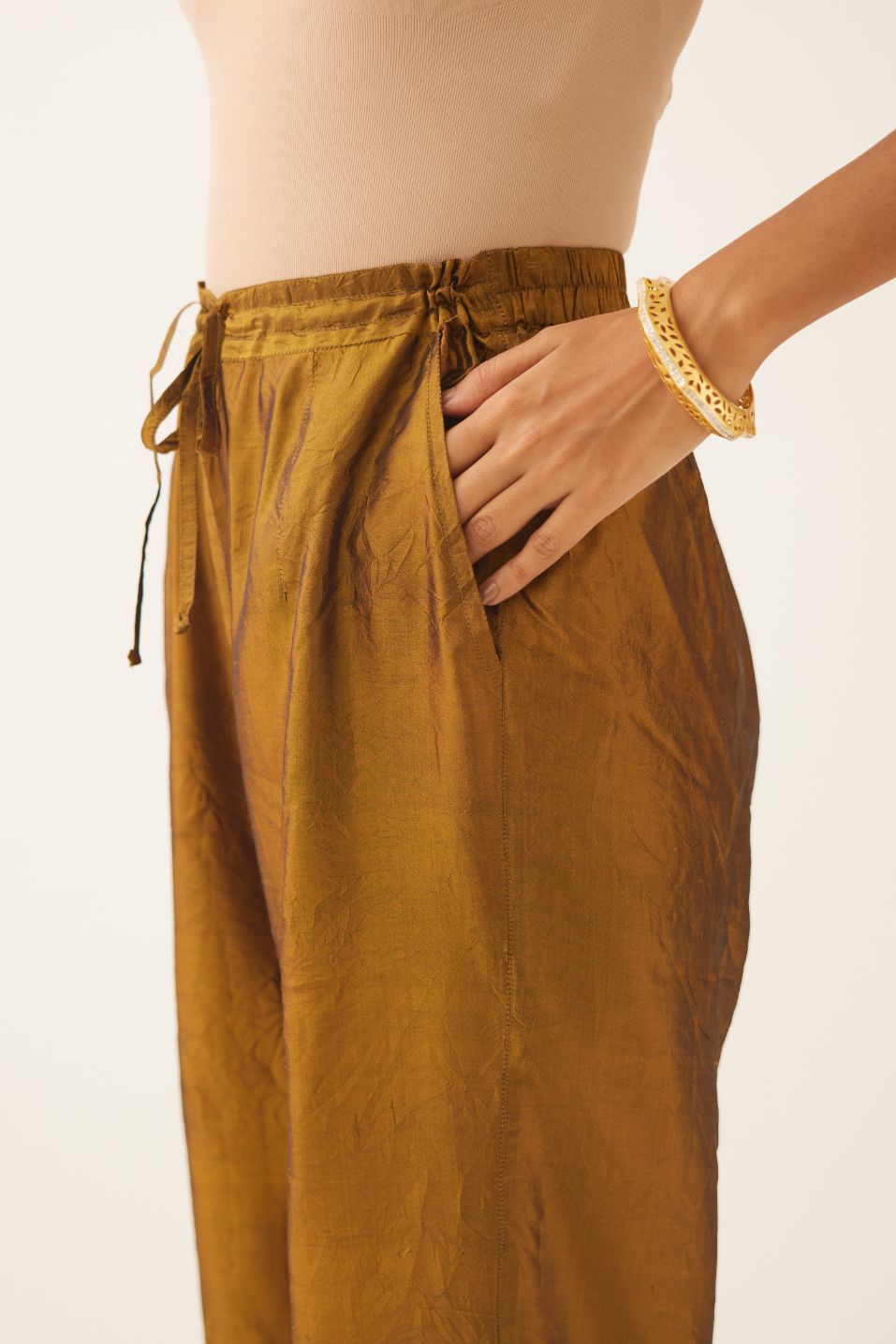 Golden olive silk straight pants with dori and silk thread embroidery.