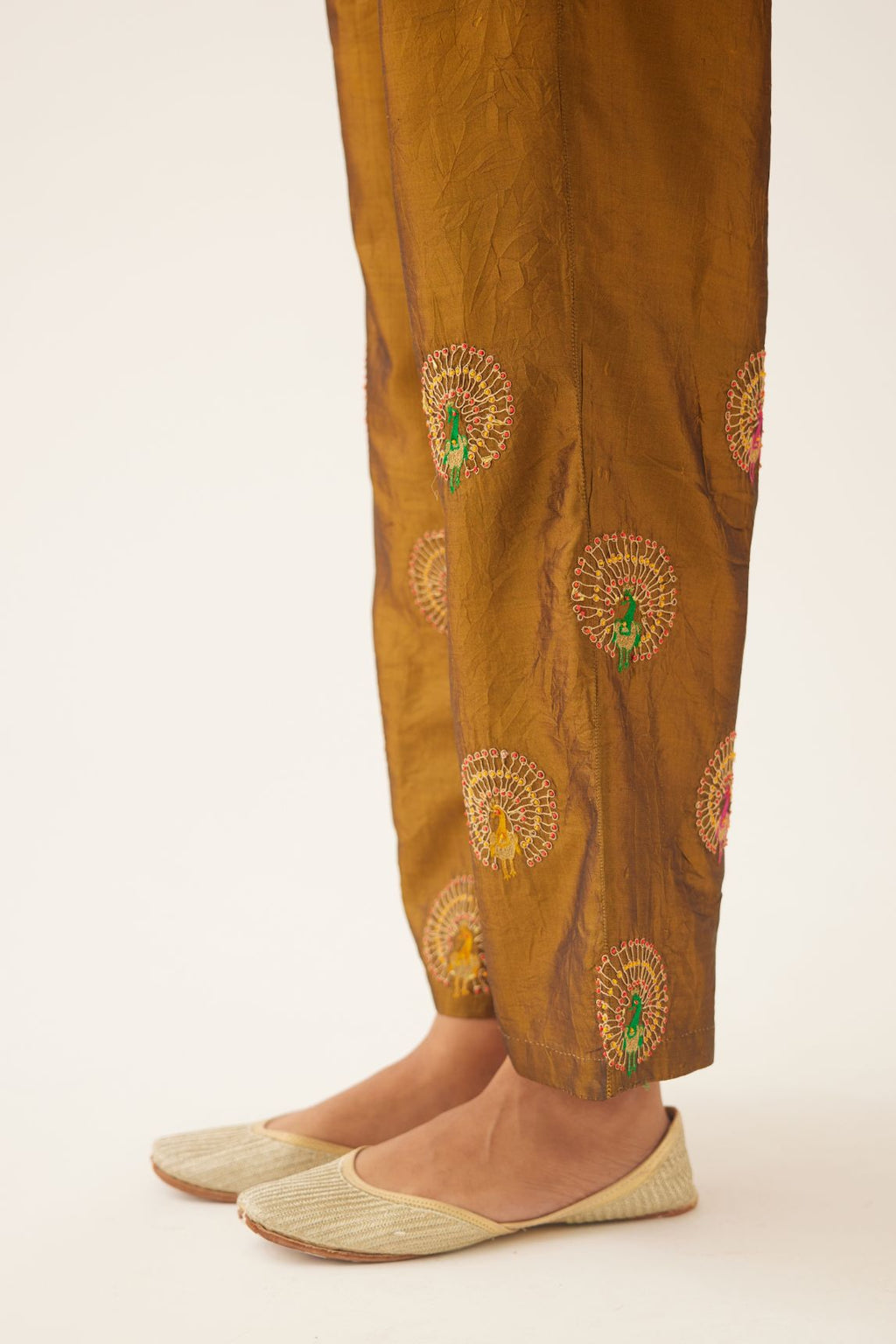 Golden olive silk straight pants with dori and silk thread embroidery.