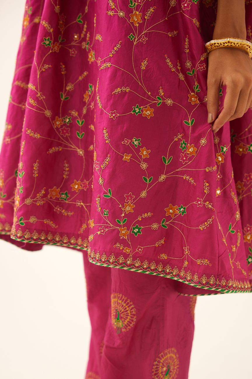 Jazz berry A-line short silk kurta set with all over embroidery, highlighted with sequins and bead work, paired with Jaz berry silk straight pants with dori and silk thread embroidery.