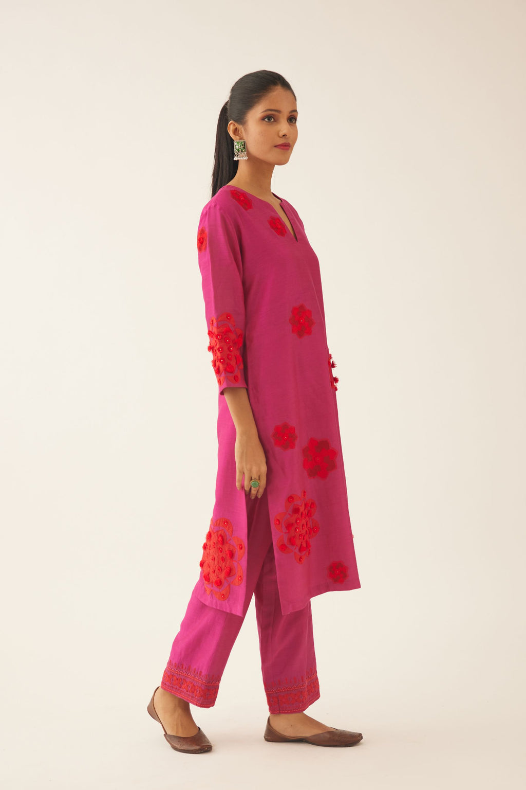 Fushcia silk chanderi straight kurta set with 3/4th sleeve, highlighted with red patch, tassles & sequence work.