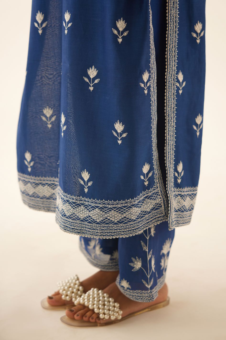 Blue silk chanderi straight kurta set with all over off white silk thread embroidery.