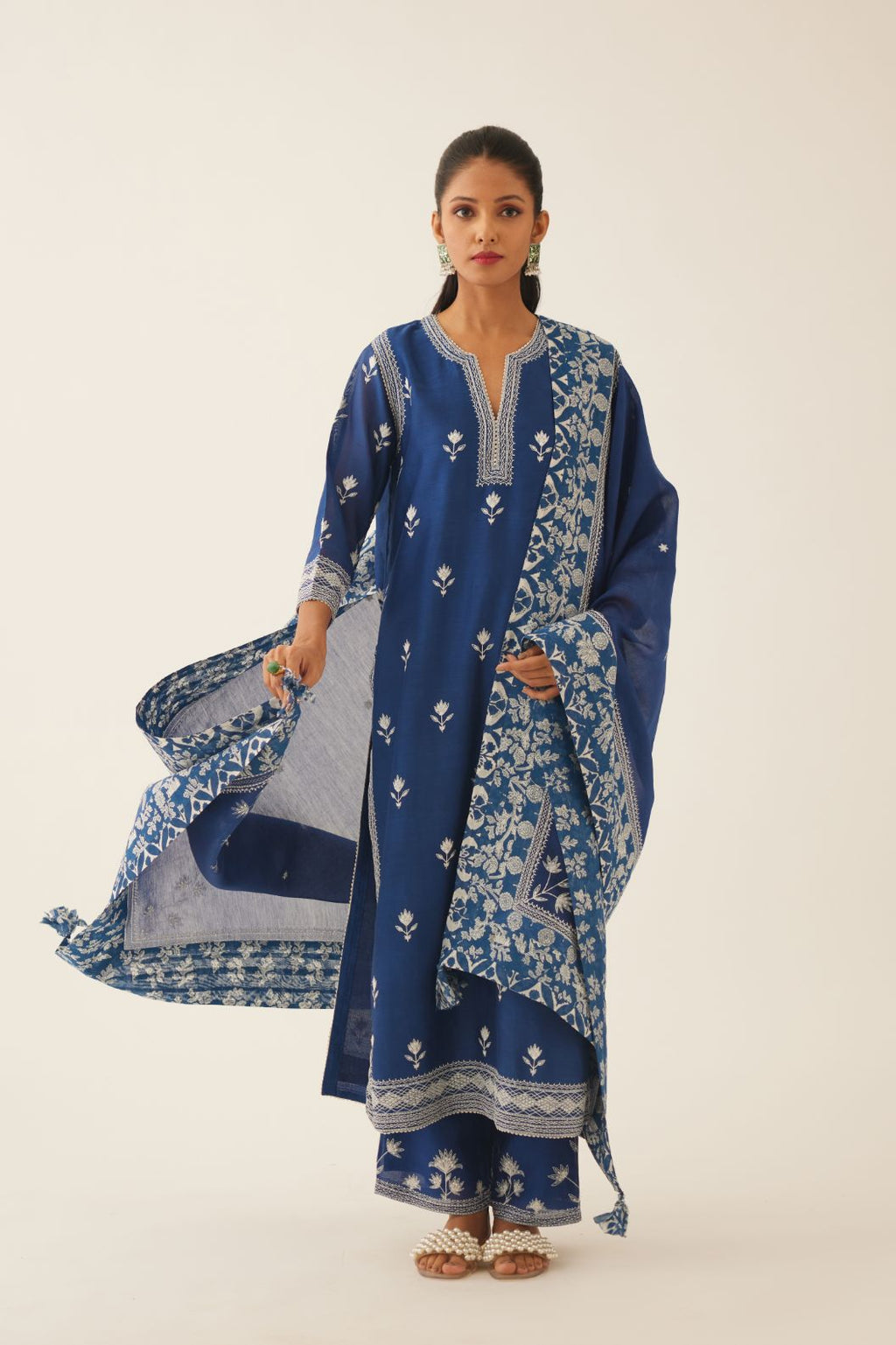 Blue silk chanderi dupatta highlighted with all-over off white thread embroidery and mixed printed border running along all edges.