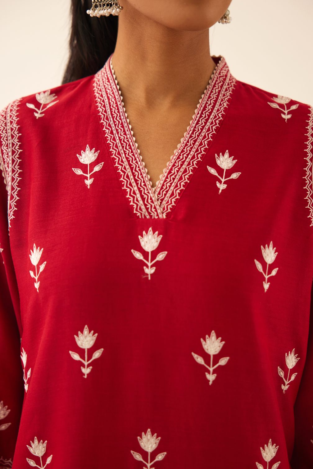 Red silk chanderi mid length straight kurta set with all over off white silk thread embroidery.