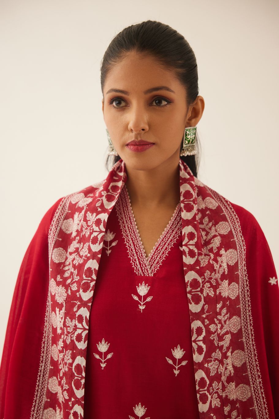 Red silk chanderi dupatta highlighted with all-over off white thread embroidery and mixed printed border running along all edges.