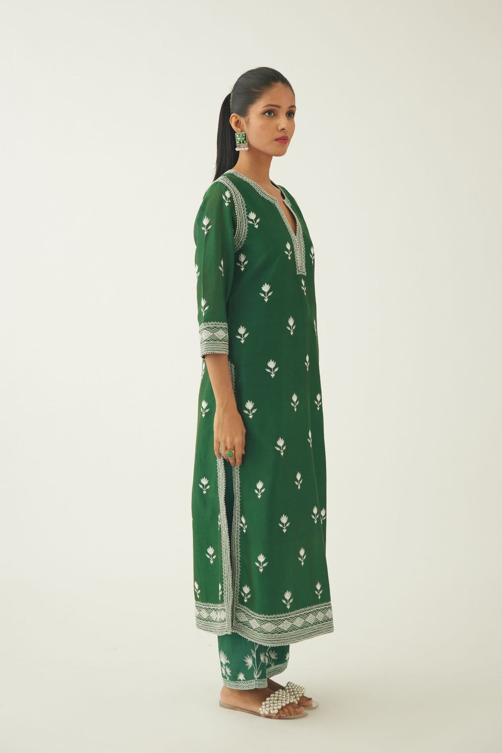 Green silk chanderi straight kurta set with all over off white silk thread embroidery.