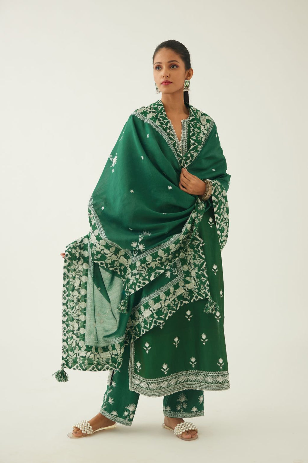 Green silk chanderi dupatta highlighted with all-over off white thread embroidery and mixed printed border running along all edges.