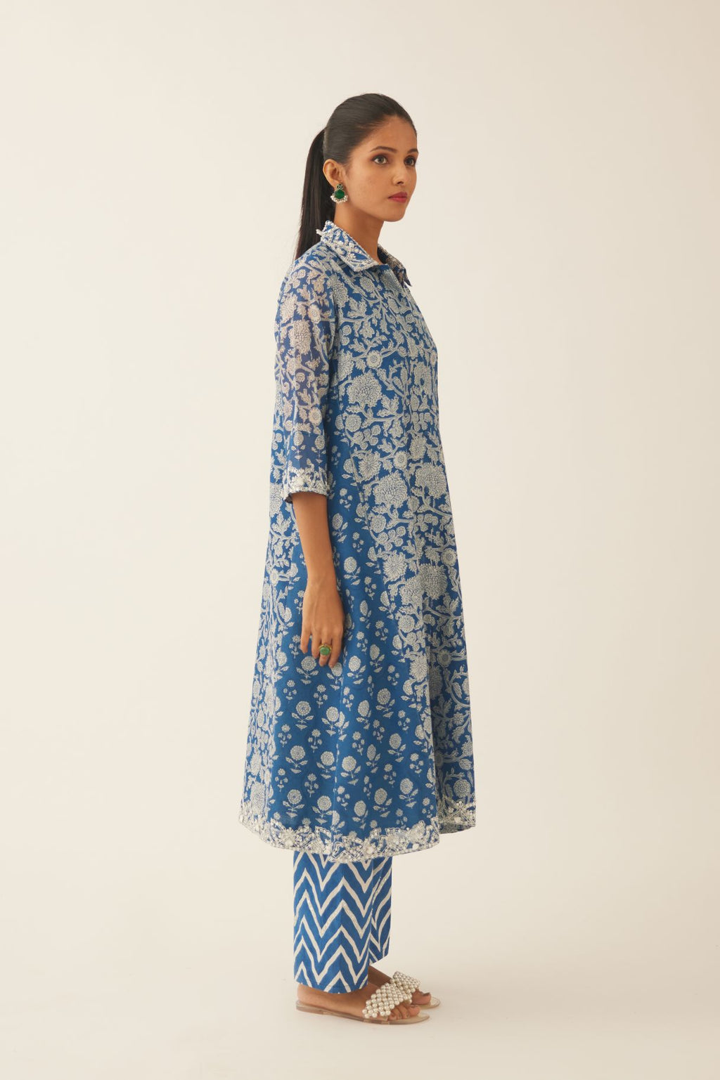 Blue hand block printed A-line short kurta with sequins, tassels and bead work, paired with blue & off white cotton hand block printed straight pants detailed with sequin and bead work at hem.