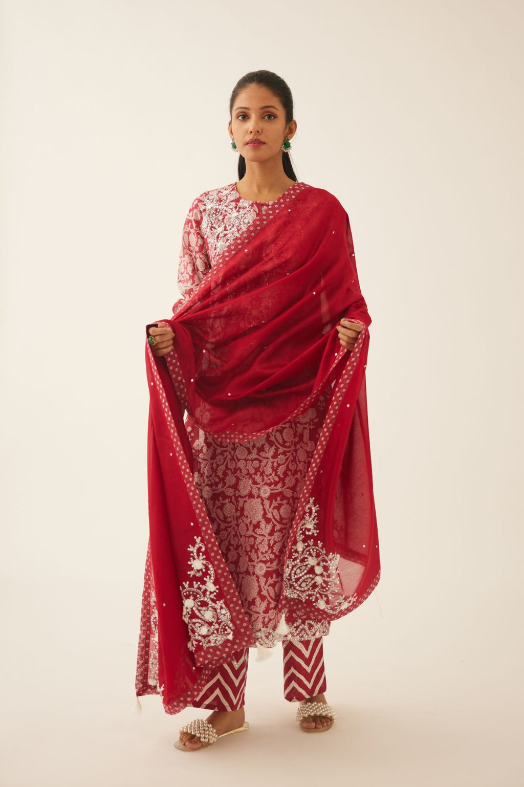 Red hand block printed kalidar straight kurta set, highlighted with sequin, tassels & bead work.