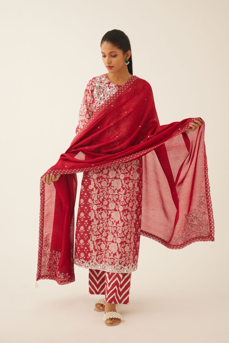 Red silk chanderi dupatta highlighted with sequin, tassels and bead work boota at corners and printed border running along all edges.