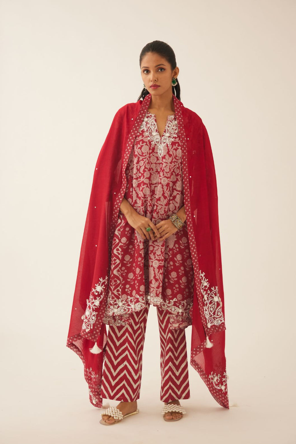 Red silk chanderi dupatta highlighted with sequin, tassels and bead work boota at corners and printed border running along all edges.