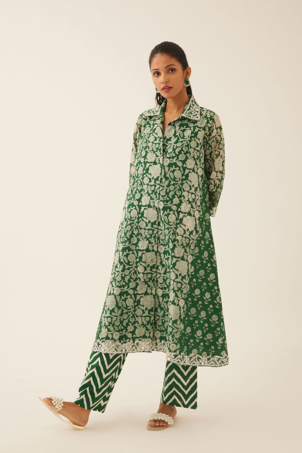 Green hand block printed A-line short kurta with sequins, tassels and bead work, paired with green & off white cotton hand block printed straight pants detailed with sequin and bead work at hem.