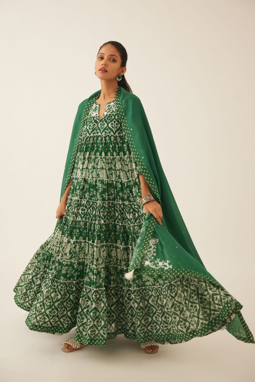 Green hand block printed multi-tiered kurta dress set with 3/4 sleeves, highlighted with sequins, tassels and bead work.