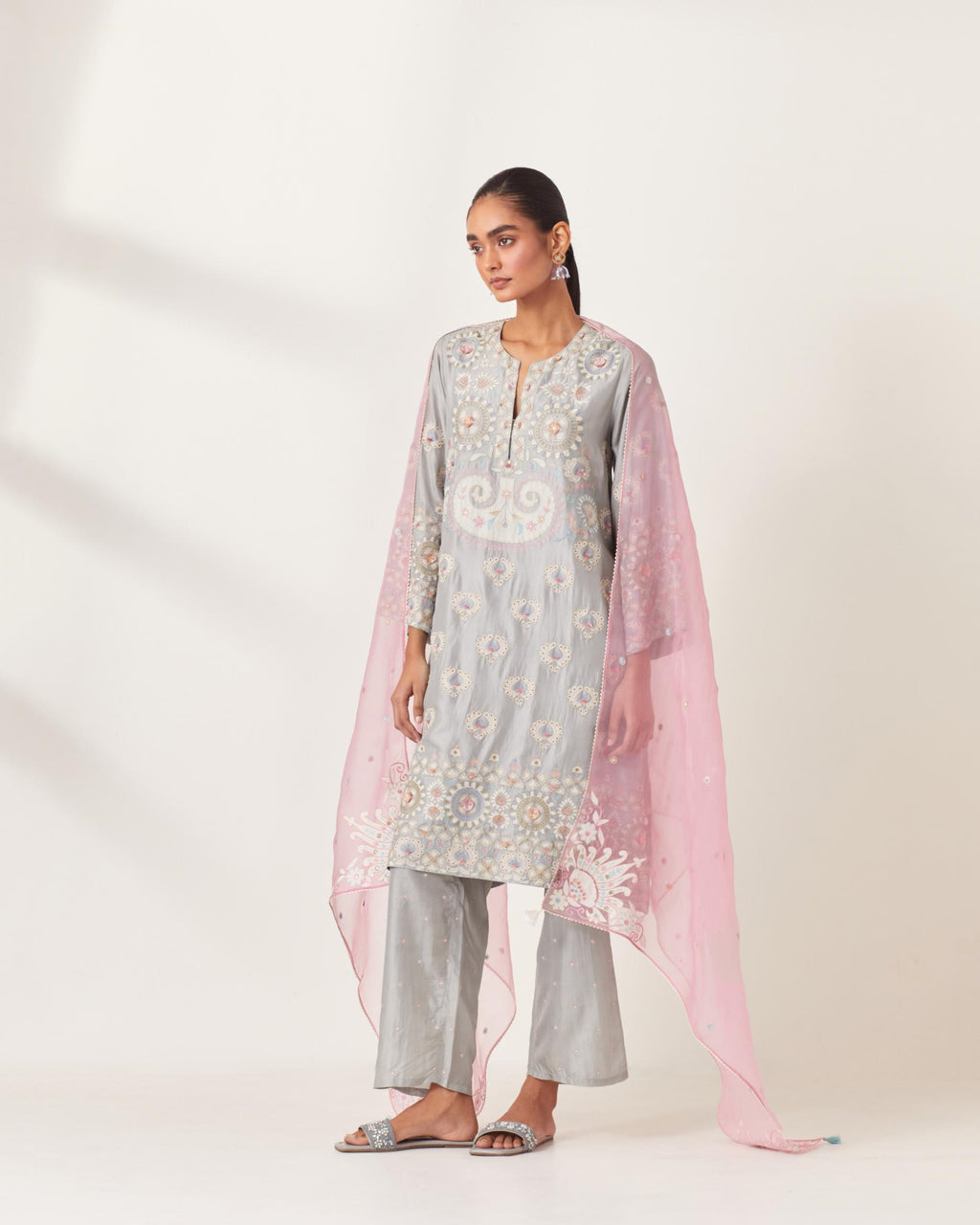 Blue silk straight hem mid-length abha style kurta set with bold appliqué embroidery along with multi-colored aari thread work and tassels.